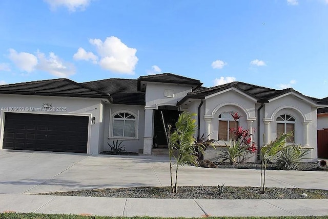 16272 SW 42nd Ter, Miami, FL 33185 - view of front of house featuring driveway, a garage, stucco siding, and a tiled roof