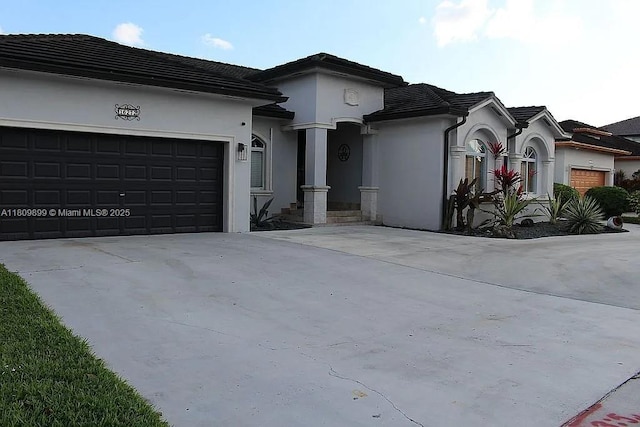 16272 SW 42nd Ter, Miami, FL 33185 - view of front of home with driveway, a garage, stucco siding, and a tile roof
