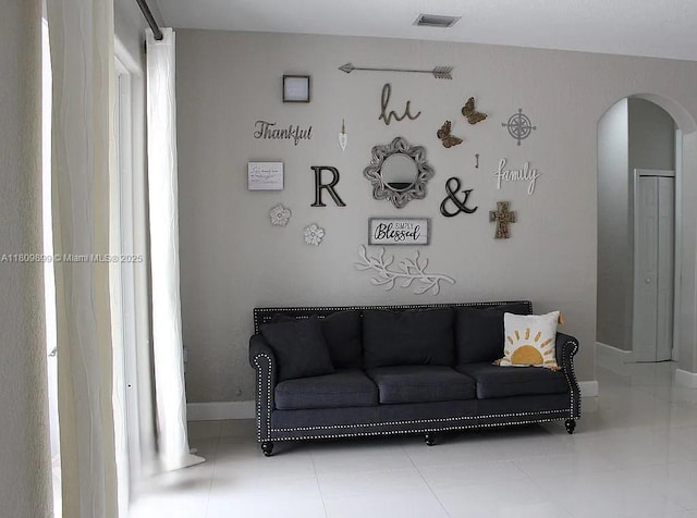 16272 SW 42nd Ter, Miami, FL 33185 - tiled living room featuring arched walkways and baseboards