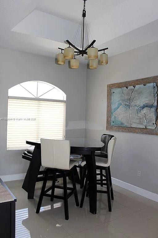 16272 SW 42nd Ter, Miami, FL 33185 - tiled dining area with a chandelier and baseboards