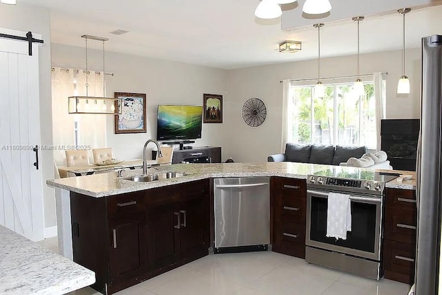 16272 SW 42nd Ter, Miami, FL 33185 - kitchen with appliances with stainless steel finishes, a sink, a barn door, light tile patterned floors, and dark brown cabinets