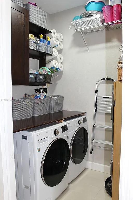16272 SW 42nd Ter, Miami, FL 33185 - laundry room featuring separate washer and dryer, cabinet space, and tile patterned floors