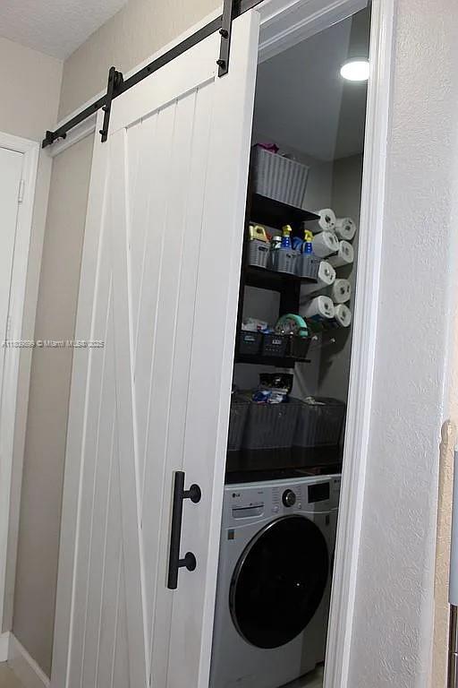 16272 SW 42nd Ter, Miami, FL 33185 - laundry room with washer / clothes dryer and a barn door