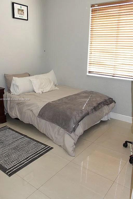 16272 SW 42nd Ter, Miami, FL 33185 - tiled bedroom featuring baseboards