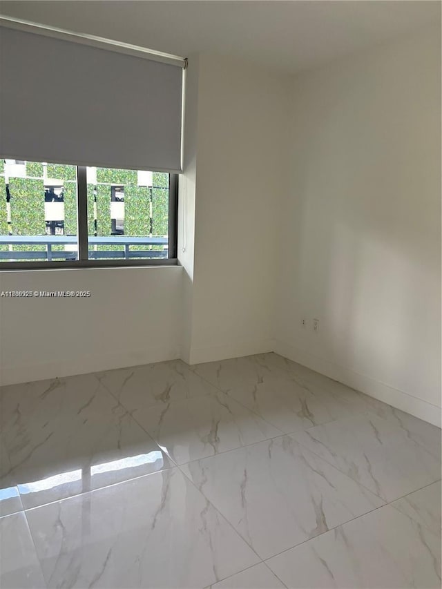 16385 Biscayne Blvd Unit 504, North Miami Beach, FL 33160 - spare room with baseboards and marble look tiles