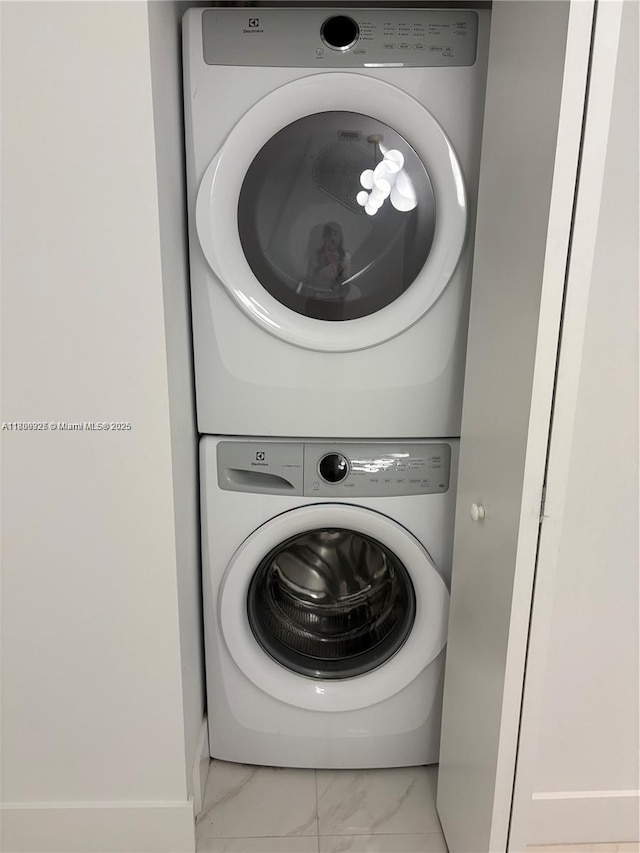 16385 Biscayne Blvd Unit 504, North Miami Beach, FL 33160 - laundry area with estacked washer and dryer and marble finish floors