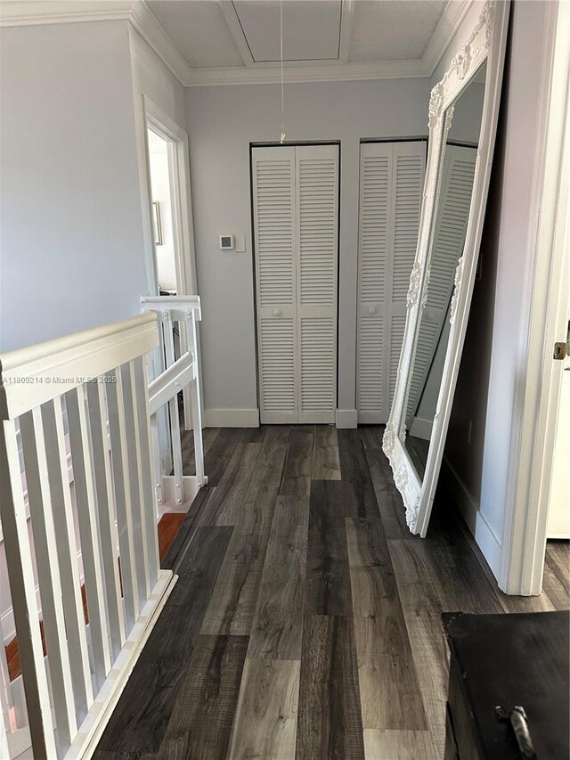 10054 SW 163rd Ct, Miami, FL 33196 - hall featuring attic access, dark wood-style flooring, an upstairs landing, and crown molding