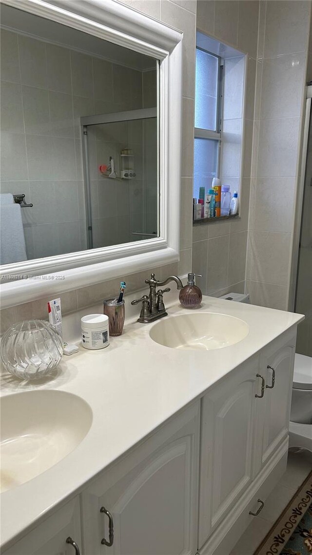10054 SW 163rd Ct, Miami, FL 33196 - full bathroom with double vanity, tile walls, and a shower stall