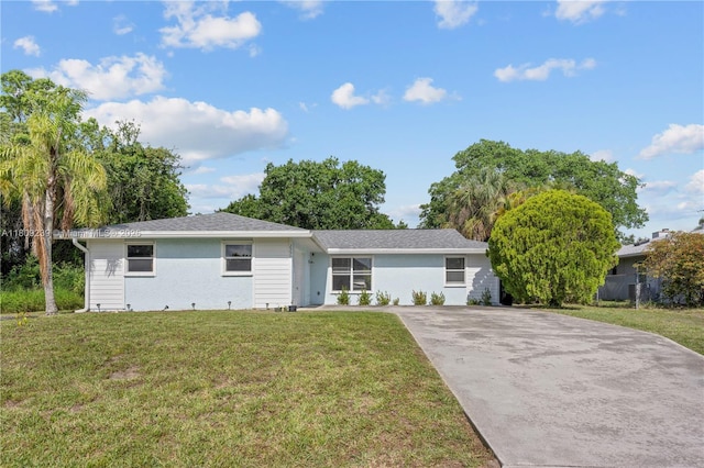 2330 SW Lejune St, Port St Lucie, FL 34953 - view of front facade featuring concrete driveway, a front lawn, and stucco siding