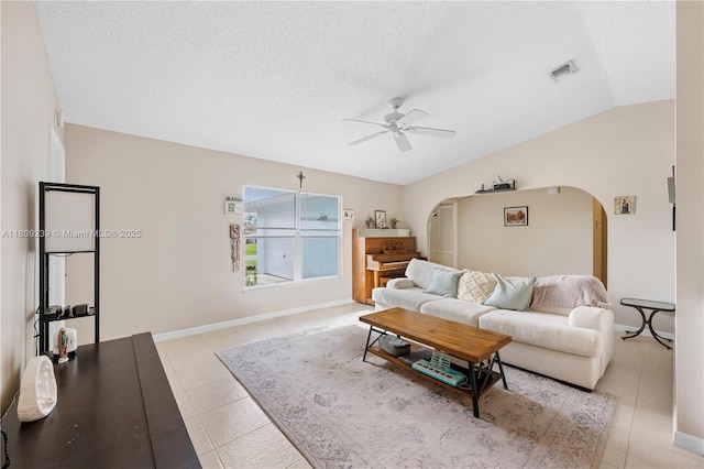 2330 SW Lejune St, Port St Lucie, FL 34953 - living area featuring arched walkways, ceiling fan, light tile patterned floors, a textured ceiling, and baseboards