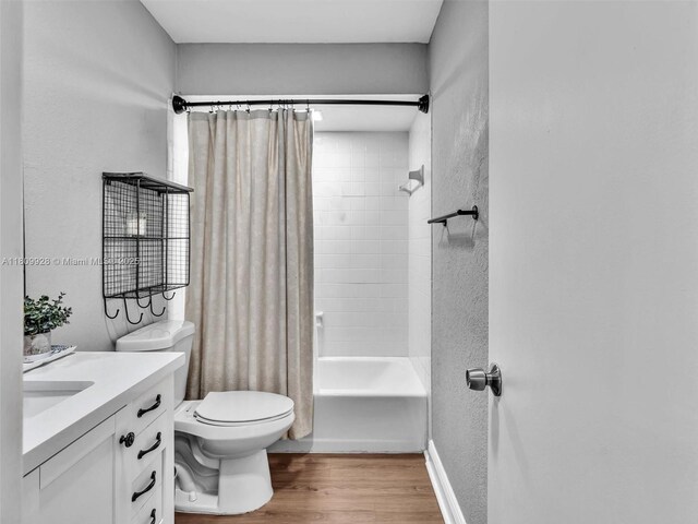 1489 Fairway Rd, Pembroke Pines, FL 33026 - bathroom with vanity, shower / bath combination with curtain, wood finished floors, toilet, and a textured wall