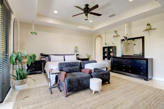 7753 SW 193rd St, Cutler Bay, FL 33157 - bedroom with arched walkways, a tray ceiling, tile patterned floors, recessed lighting, and ceiling fan
