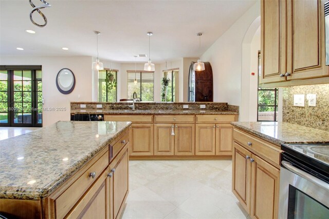 7753 SW 193rd St, Cutler Bay, FL 33157 - kitchen with a sink, light stone counters, a center island, arched walkways, and recessed lighting