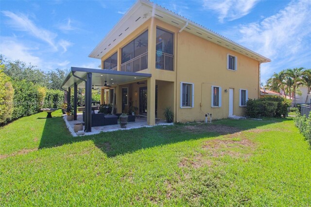 7753 SW 193rd St, Cutler Bay, FL 33157 - back of property with a ceiling fan, a patio area, outdoor lounge area, stucco siding, and a sunroom