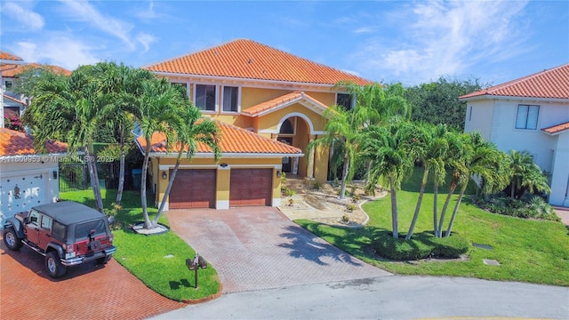 7753 SW 193rd St, Cutler Bay, FL 33157 - mediterranean / spanish-style house featuring a tile roof, decorative driveway, a front yard, and stucco siding