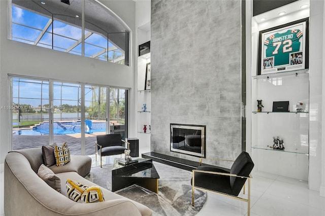 10457 Laurel Rd, Davie, FL 33328 - living room with a towering ceiling, a tiled fireplace, plenty of natural light, and tile patterned floors