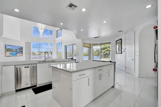 10457 Laurel Rd, Davie, FL 33328 - kitchen featuring stainless steel dishwasher, a center island, a sink, white cabinetry, and recessed lighting
