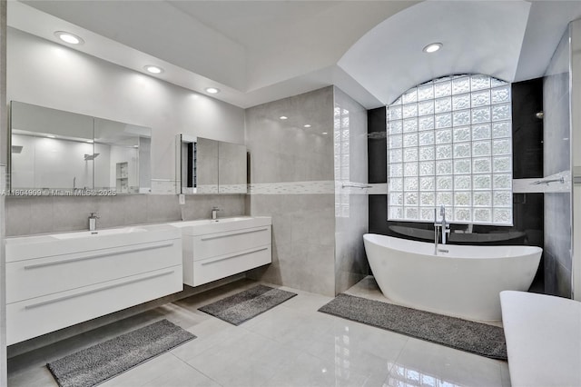 10457 Laurel Rd, Davie, FL 33328 - bathroom with tile walls, vanity, a freestanding bath, and recessed lighting