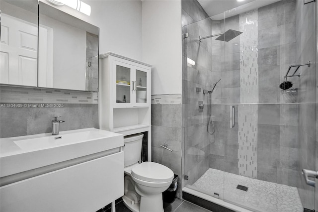 10457 Laurel Rd, Davie, FL 33328 - bathroom with toilet, a stall shower, vanity, tile patterned floors, and tile walls