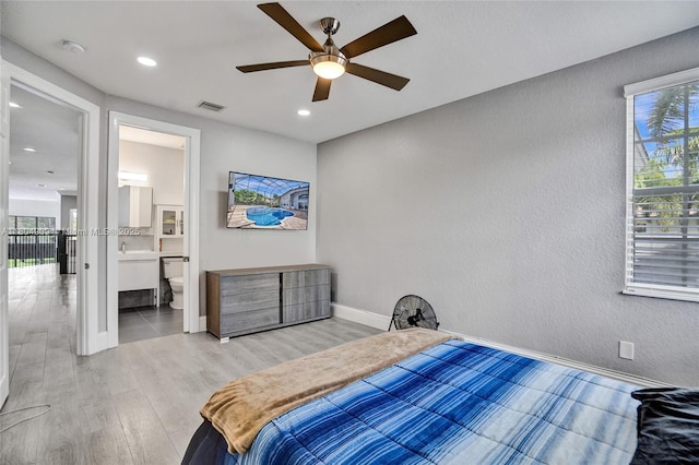 10457 Laurel Rd, Davie, FL 33328 - bedroom with wood finished floors, recessed lighting, a textured wall, baseboards, and ensuite bathroom