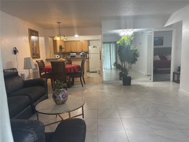 15428 SW 85th Ln Unit 159, Miami, FL 33193 - living area with a textured ceiling, a chandelier, and light marble finish floors
