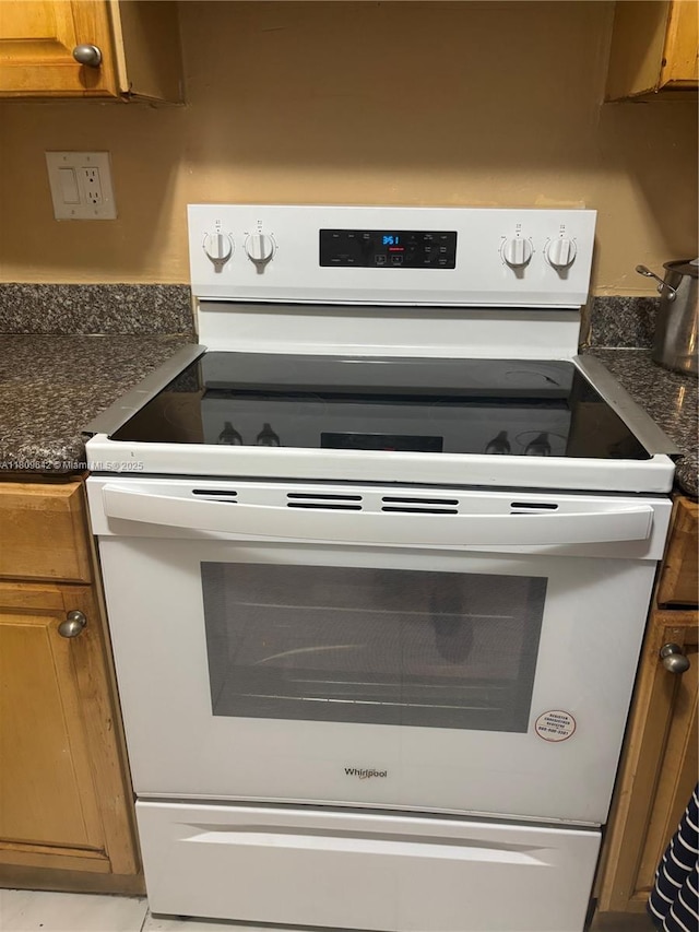 15428 SW 85th Ln Unit 159, Miami, FL 33193 - kitchen view of white electric stove, dark countertops, and brown cabinets