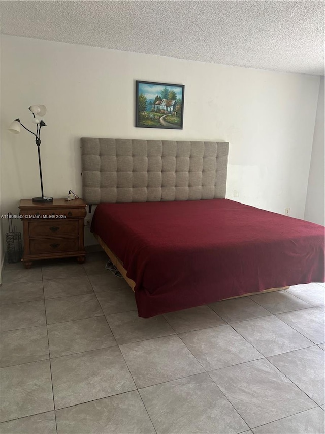 15428 SW 85th Ln Unit 159, Miami, FL 33193 - bedroom featuring a textured ceiling and light tile patterned flooring
