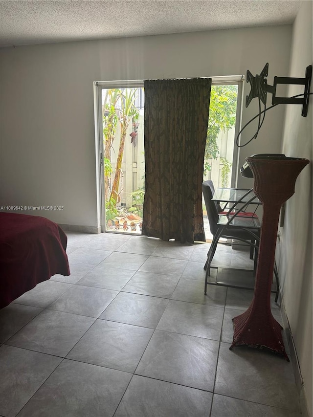 15428 SW 85th Ln Unit 159, Miami, FL 33193 - bedroom featuring multiple windows, a textured ceiling, and access to outside