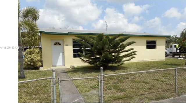 7821 NW 30th St, Davie, FL 33024 - view of front facade with stucco siding and a gate