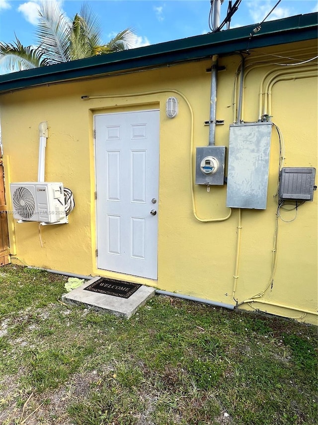 7821 NW 30th St, Davie, FL 33024 - view of exterior entry with stucco siding and a cooling unit