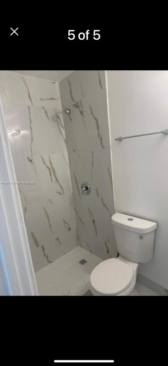 7821 NW 30th St, Davie, FL 33024 - bathroom featuring a marble finish shower and toilet