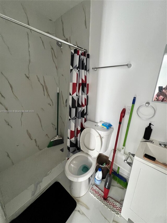 7821 NW 30th St, Davie, FL 33024 - full bathroom with toilet, vanity, a marble finish shower, and marble look tiles