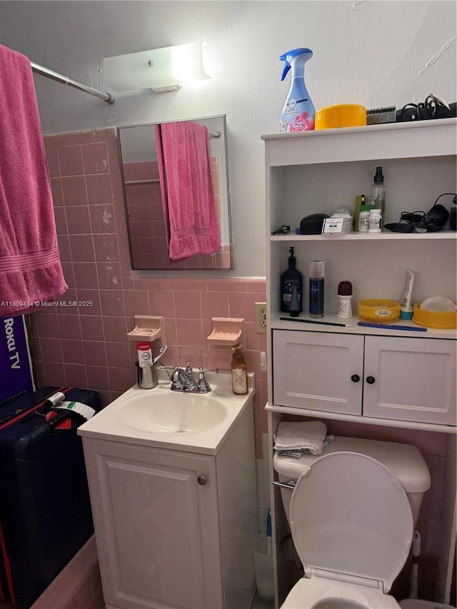 7951 NW 30th St, Davie, FL 33024 - bathroom featuring vanity, toilet, and tile walls