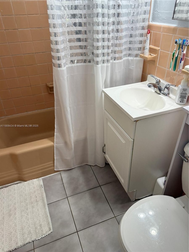 7951 NW 30th St, Davie, FL 33024 - bathroom with vanity, toilet, shower / bath combo, tile patterned flooring, and tile walls