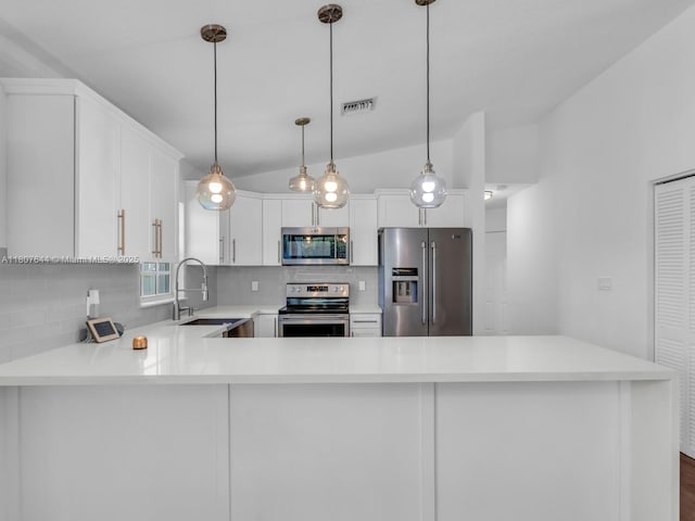 17654 SW 5th Ct, Pembroke Pines, FL 33029 - kitchen featuring appliances with stainless steel finishes, a sink, backsplash, light countertops, and vaulted ceiling