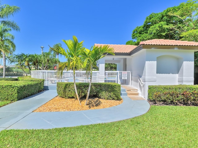 17654 SW 5th Ct, Pembroke Pines, FL 33029 - mediterranean / spanish house with stucco siding, a tile roof, covered porch, and a front lawn