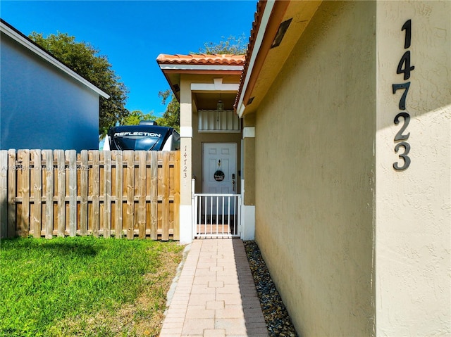 14723 SW 155th Pl, Miami, FL 33196 - view of exterior entry featuring stucco siding and a tiled roof