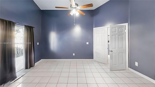 14723 SW 155th Pl, Miami, FL 33196 - spare room featuring ceiling fan, baseboards, a high ceiling, and light tile patterned flooring