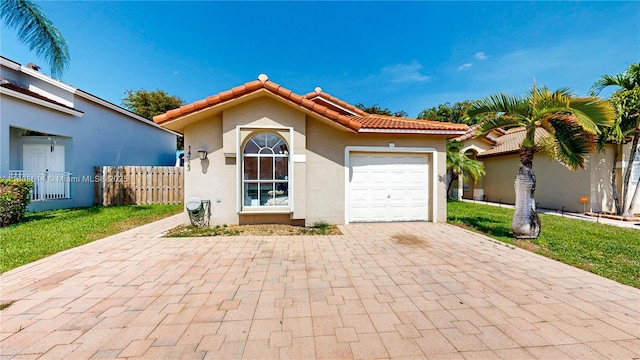 14723 SW 155th Pl, Miami, FL 33196 - mediterranean / spanish home with a tile roof, stucco siding, an attached garage, and decorative driveway