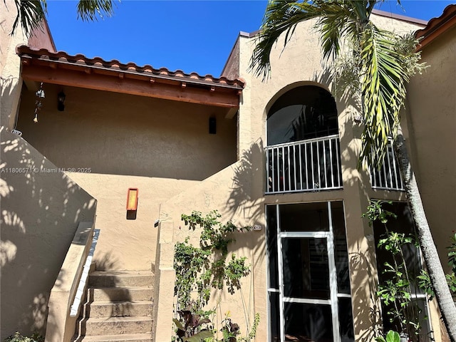 301 SW 86th Ave Unit 208, Pembroke Pines, FL 33025 - back of house featuring stucco siding, a balcony, and a tile roof