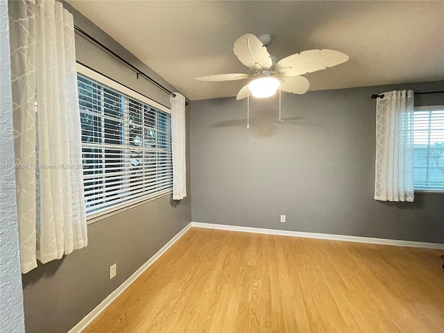 301 SW 86th Ave Unit 208, Pembroke Pines, FL 33025 - empty room featuring wood finished floors, a ceiling fan, baseboards, and a textured ceiling
