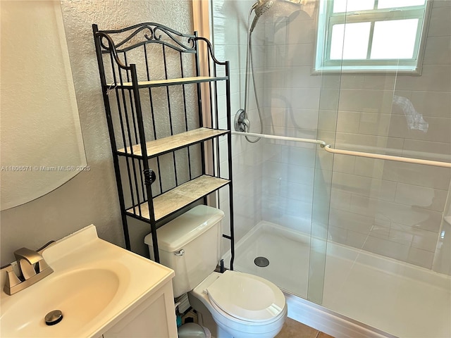 301 SW 86th Ave Unit 208, Pembroke Pines, FL 33025 - bathroom with a textured wall, tiled shower, vanity, and toilet