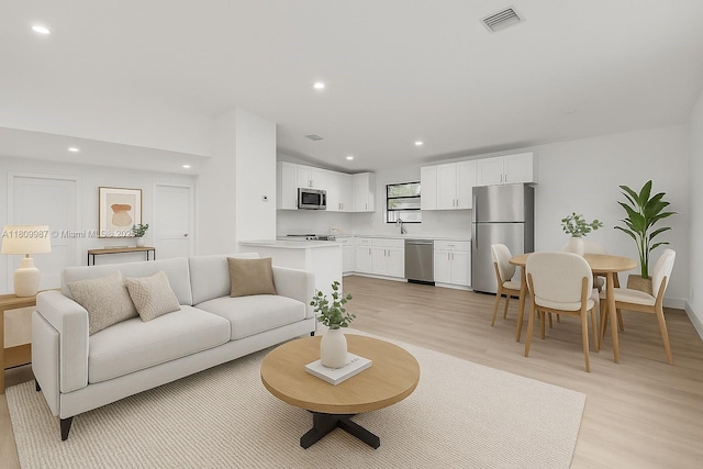 235 SW 3rd Ct, Deerfield Beach, FL 33441 - living area featuring light wood finished floors and recessed lighting