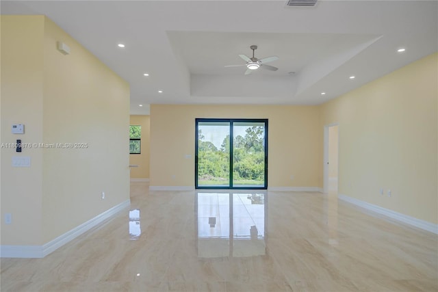 637 Cardinal St E, Lehigh Acres, FL 33974 - empty room featuring a ceiling fan, recessed lighting, a raised ceiling, and baseboards