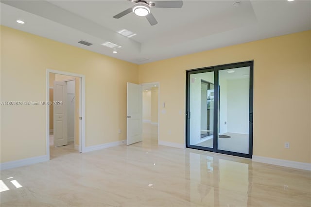 637 Cardinal St E, Lehigh Acres, FL 33974 - spare room featuring a raised ceiling, a ceiling fan, recessed lighting, and baseboards