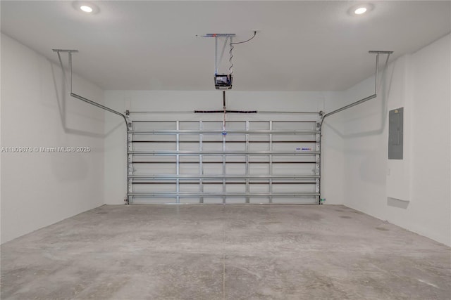 637 Cardinal St E, Lehigh Acres, FL 33974 - garage featuring electric panel, a garage door opener, and recessed lighting
