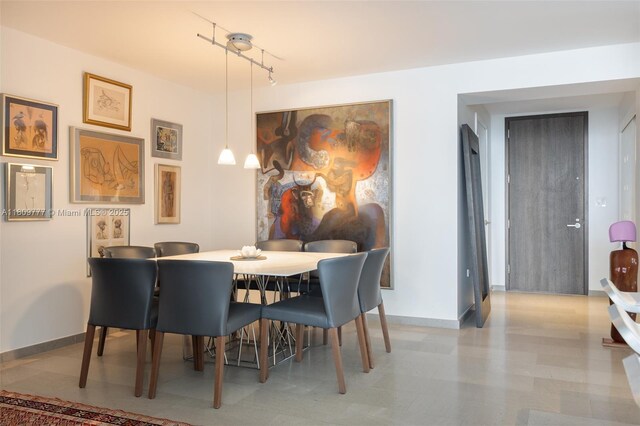 68 SE 6th St Unit 1703, Miami, FL 33131 - dining space with baseboards and track lighting