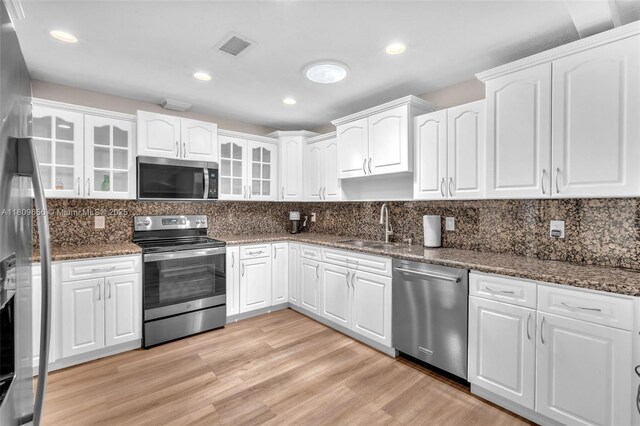4271 SW 67th Ter, Davie, FL 33314 - kitchen with stainless steel appliances, a sink, glass insert cabinets, dark stone counters, and recessed lighting