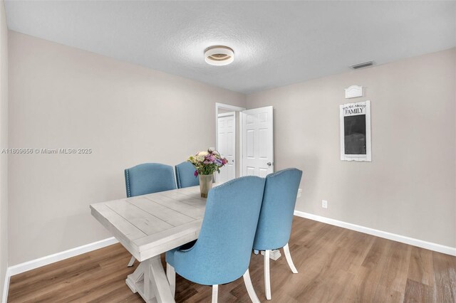 4271 SW 67th Ter, Davie, FL 33314 - dining space with baseboards, wood finished floors, and a textured ceiling