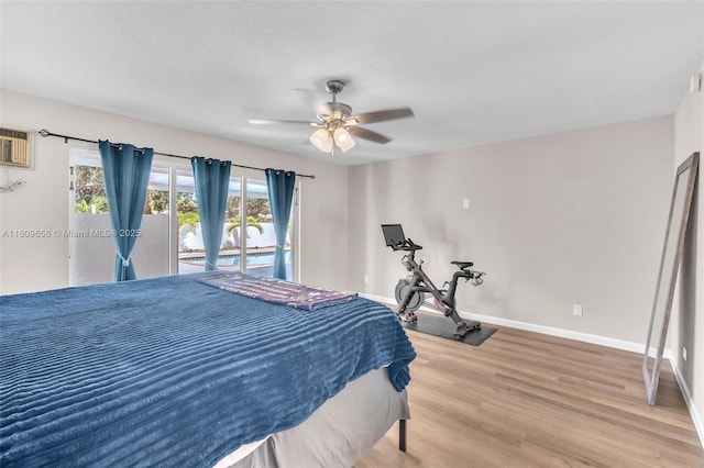 4271 SW 67th Ter, Davie, FL 33314 - bedroom featuring wood finished floors, baseboards, access to outside, a ceiling fan, and an AC wall unit